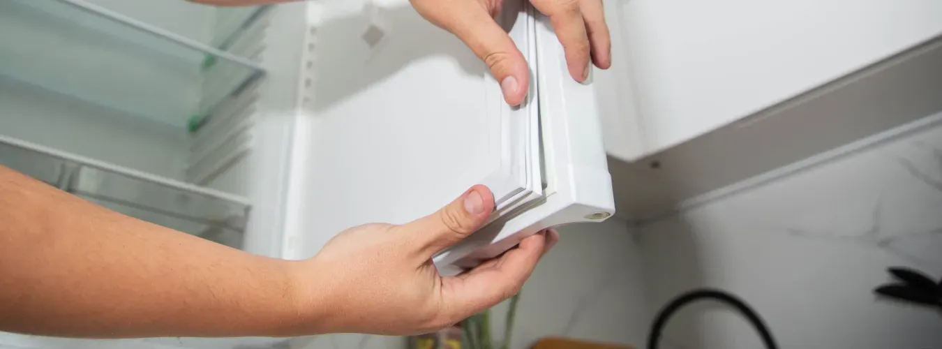 hands-checking-refrigerator-door-seal